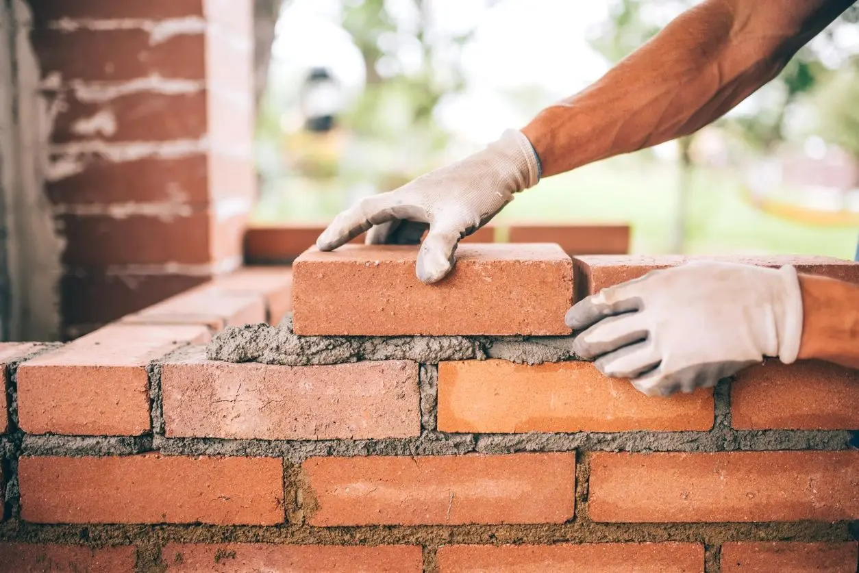 Close Up of Industrial Bricklayer Installing Bricks