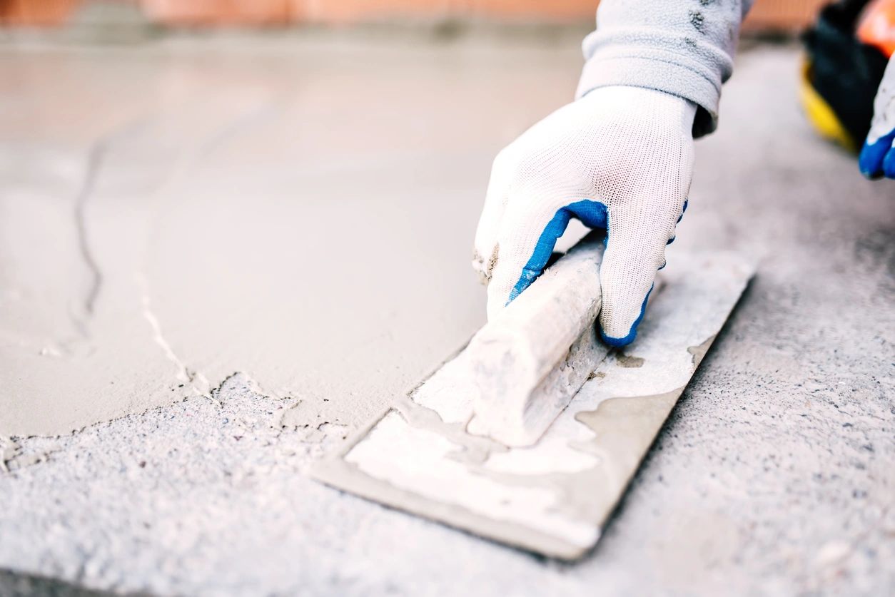 Builder Using Plastering Tool for Finishing Floor